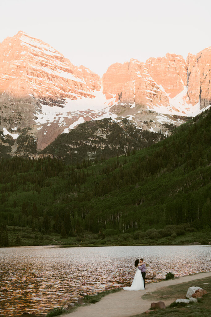 Bride and groom hiking through the Maroon Bells wilderness near Aspen
