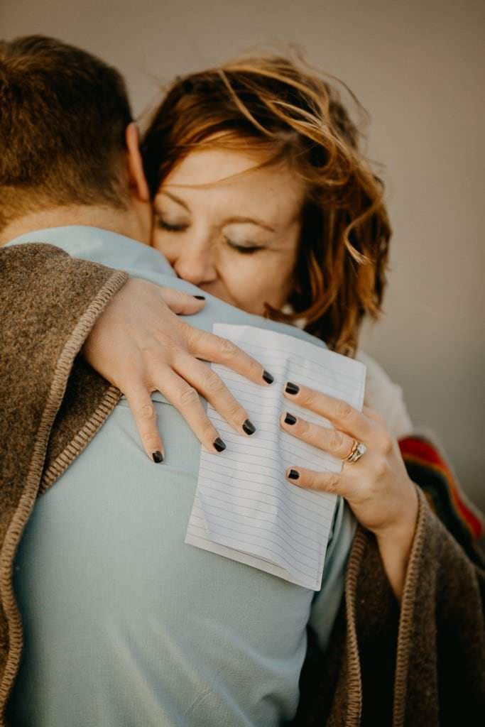 Adventure elopement couple wrapped in blankets after their ceremony