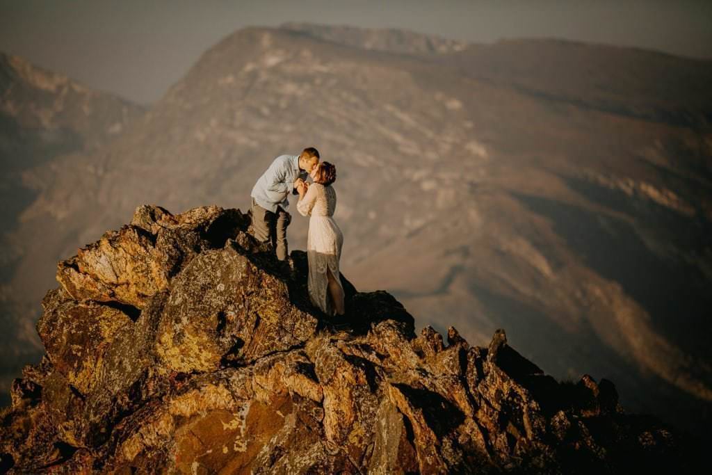 Couple hiking at sunrise during their Rocky Mountain National Park adventure elopement