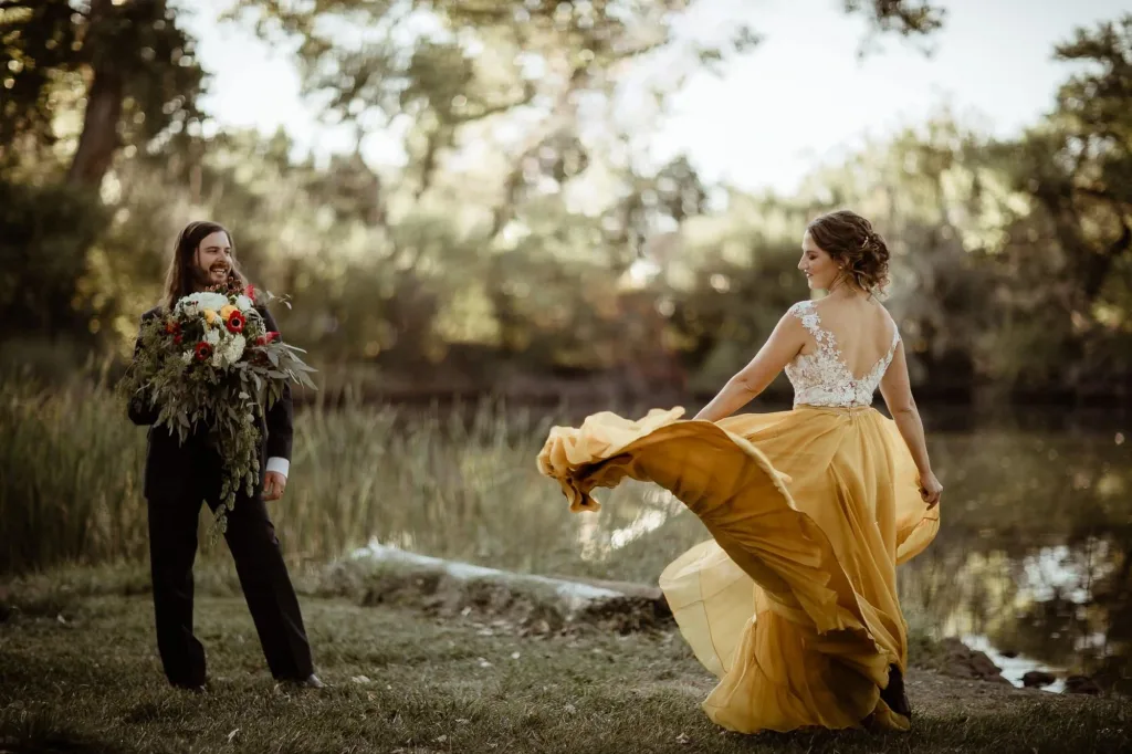 Sunset Adventure elopement at Rocky Mountain National Park. Couple in their wedding attire dancing by the alpine lake in he fall attire of forever goldens, savoring Colorado mountain views above 12,000 feet on the Trail Ridge Road in Estes Park, Colorado.