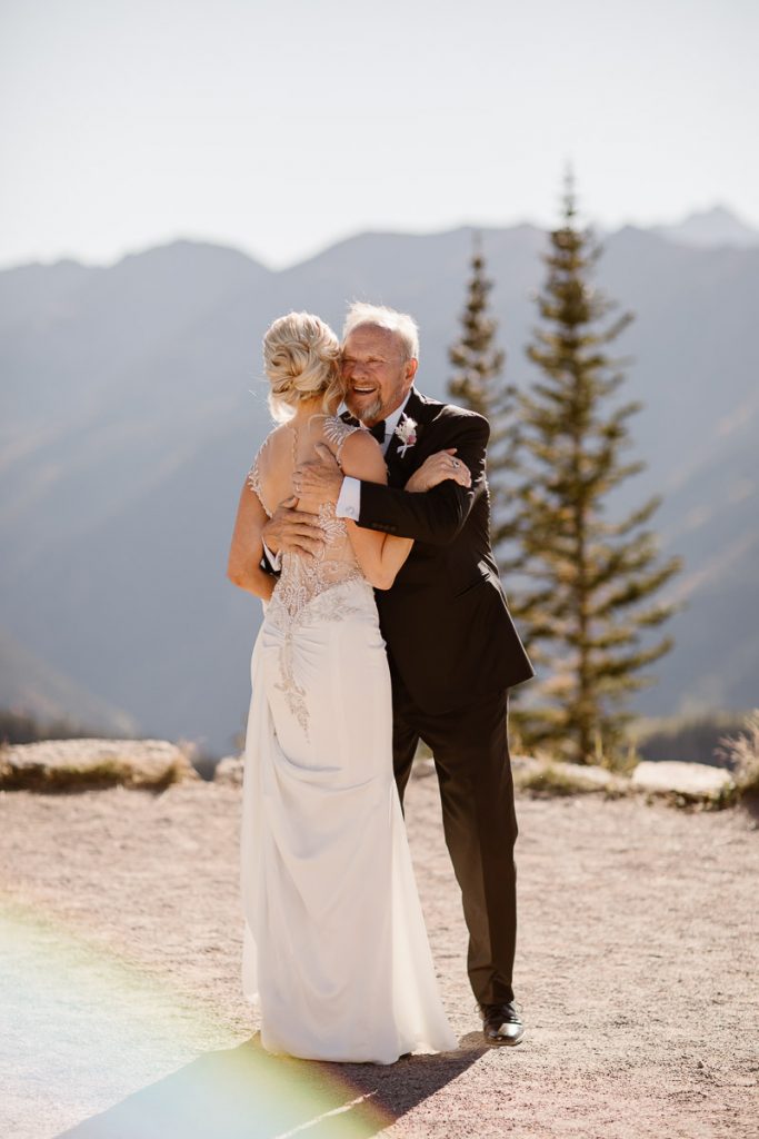 Bride sharing a first look with her father before her Aspen wedding ceremony