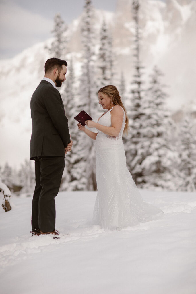 Emotional vow exchange surrounded by fresh June snowfall