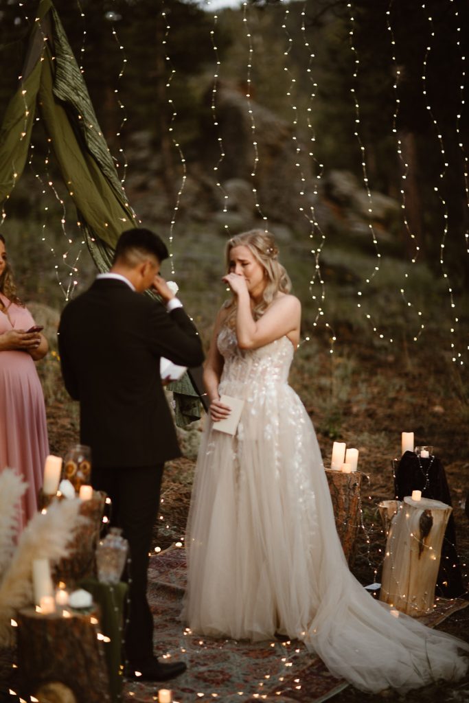 “Intimate Colorado elopement ceremony with candles glowing in soft twilight