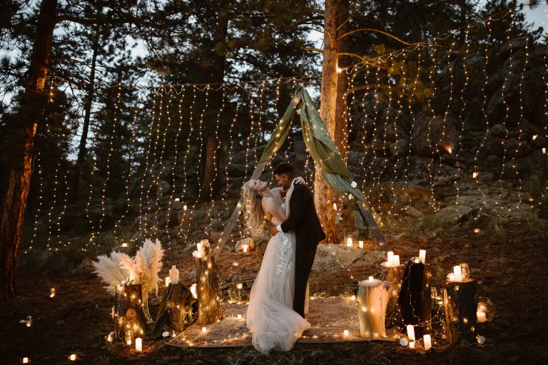 Blue hour candlelit vow ceremony in the Colorado mountains with deep blue sky