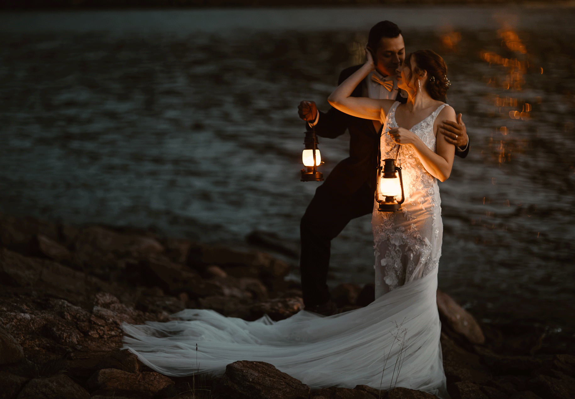 “Romantic Colorado elopement photographer captures an intimate lakeside wedding moment as the bride in a lace gown and the groom embrace while holding glowing lanterns. Set against a mountain lake at sunset, this photo highlights authentic love and adventure.”

Twilight Vows in Estes Park Colorado Colorado Elopement Photographer