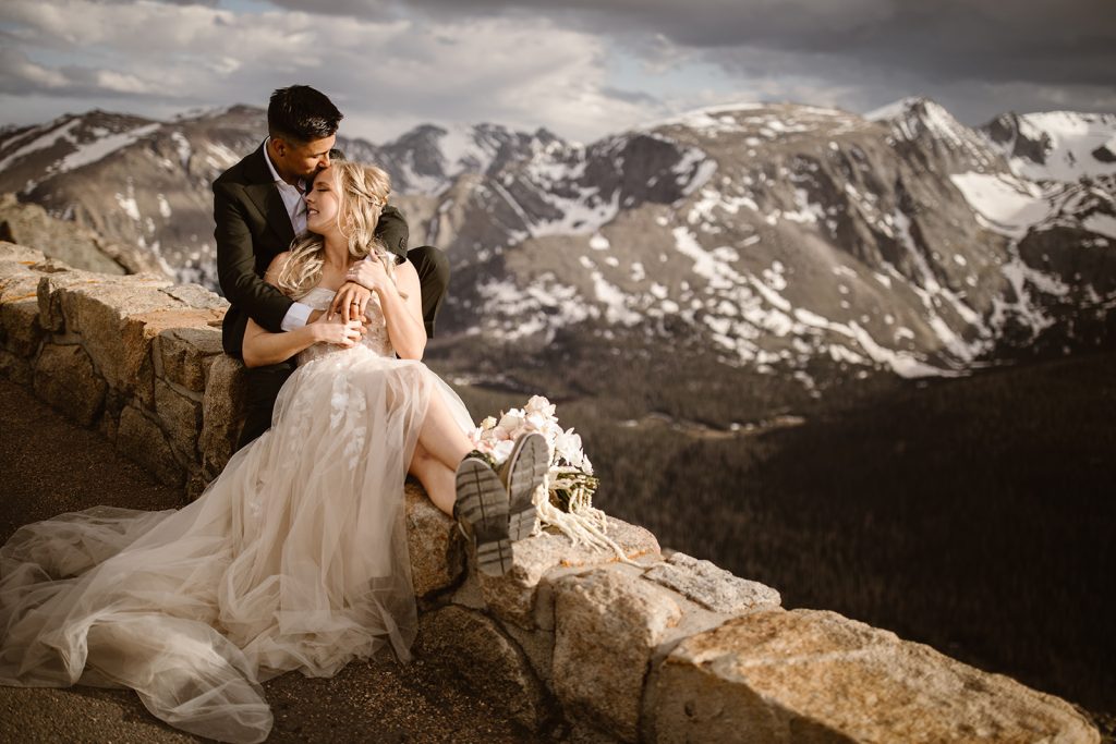 "Romantic and adventurous elopement in Rocky Mountain National Park, Colorado, featuring a couple cuddling at sunset on Trail Ridge Road — photographed by Justyna E Butler, Colorado Elopement Photographer specializing in intimate mountain weddings"