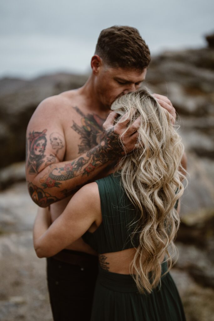 “Romantic Colorado elopement photography featuring a bride and groom holding each other under lantern light, surrounded by dramatic mountains and a vast starry night sky. An intimate and adventurous wedding moment captured in the wilderness.”