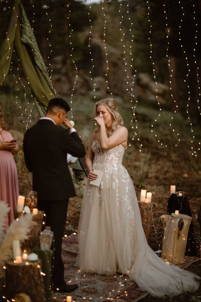 Blue hour candlelit vow ceremony in the Colorado mountains with deep blue sky