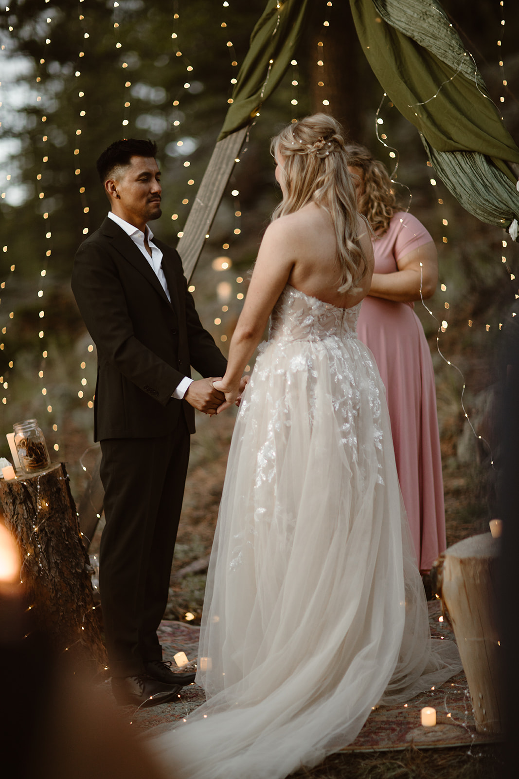 Candlelit twilight elopement with mountain silhouettes and fading blue sky
