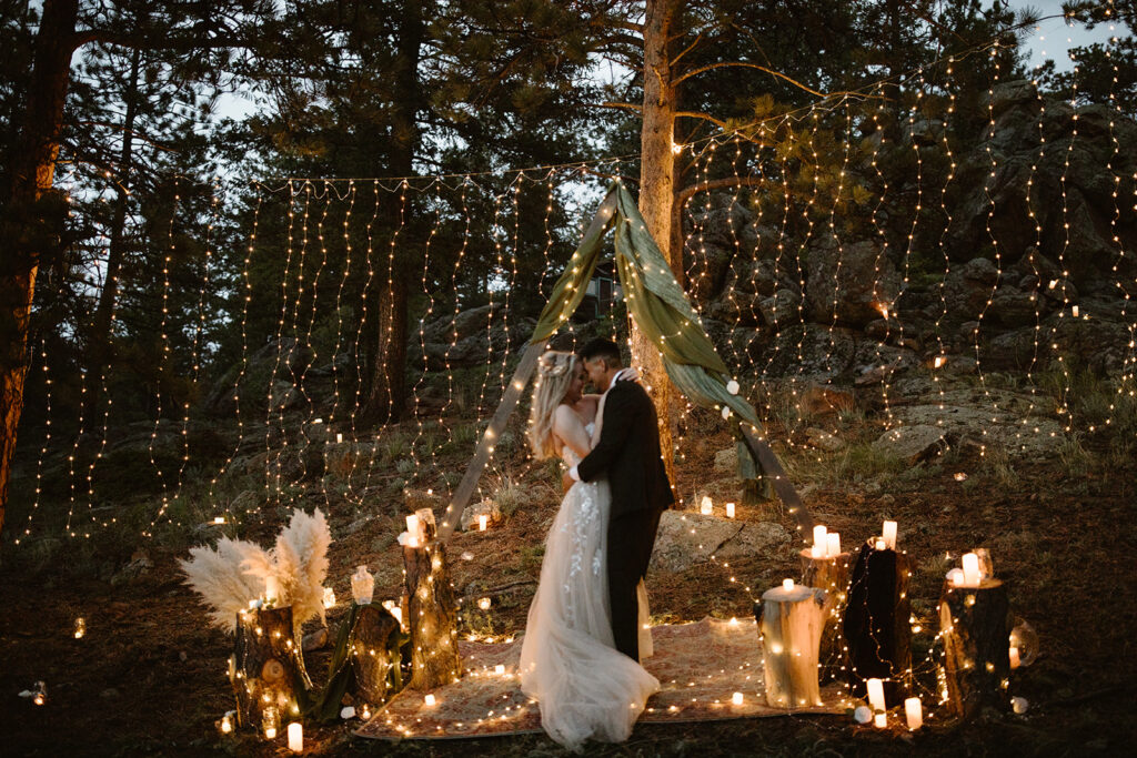 Blue hour candlelit vow ceremony in the Colorado mountains with deep blue sky
