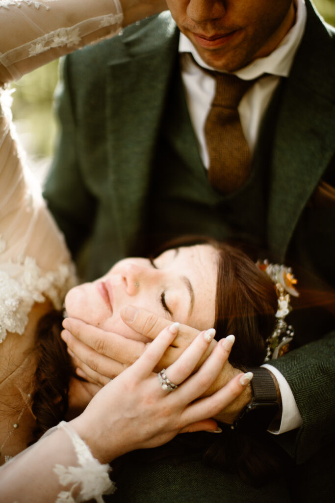 Romantic Colorado elopement portrait of a bride and groom sharing an intimate moment in the mountains.