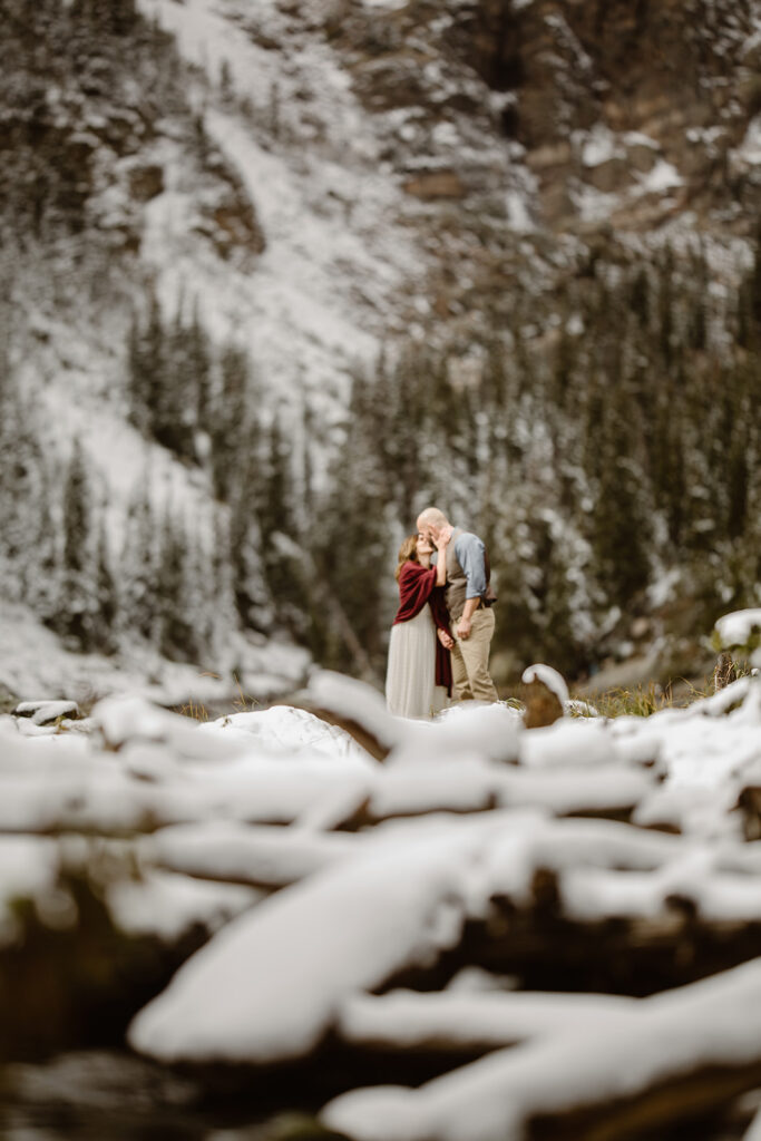A couple hiking through the Colorado mountains during their adventurous elopement, surrounded by alpine scenery and dramatic mountain peaks.