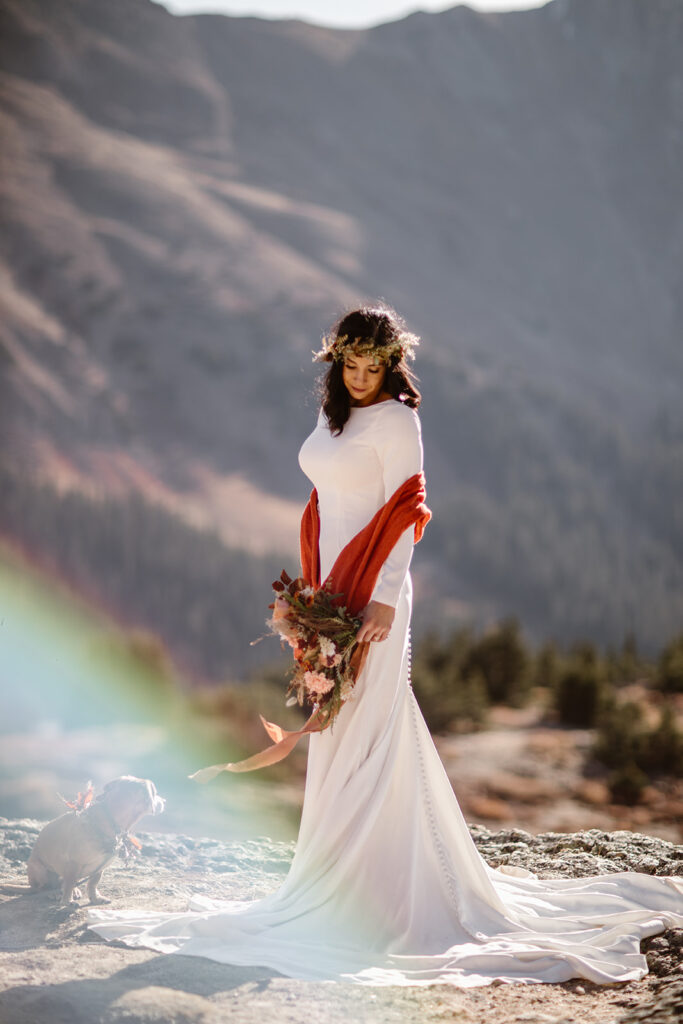 Bride's flowing ribbons attached to the adventure elopement flowers captured in the alpine wind during a Colorado mountain elopement.