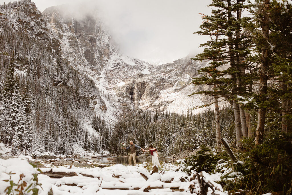 Couple hiking through the Colorado mountains on their elopement day