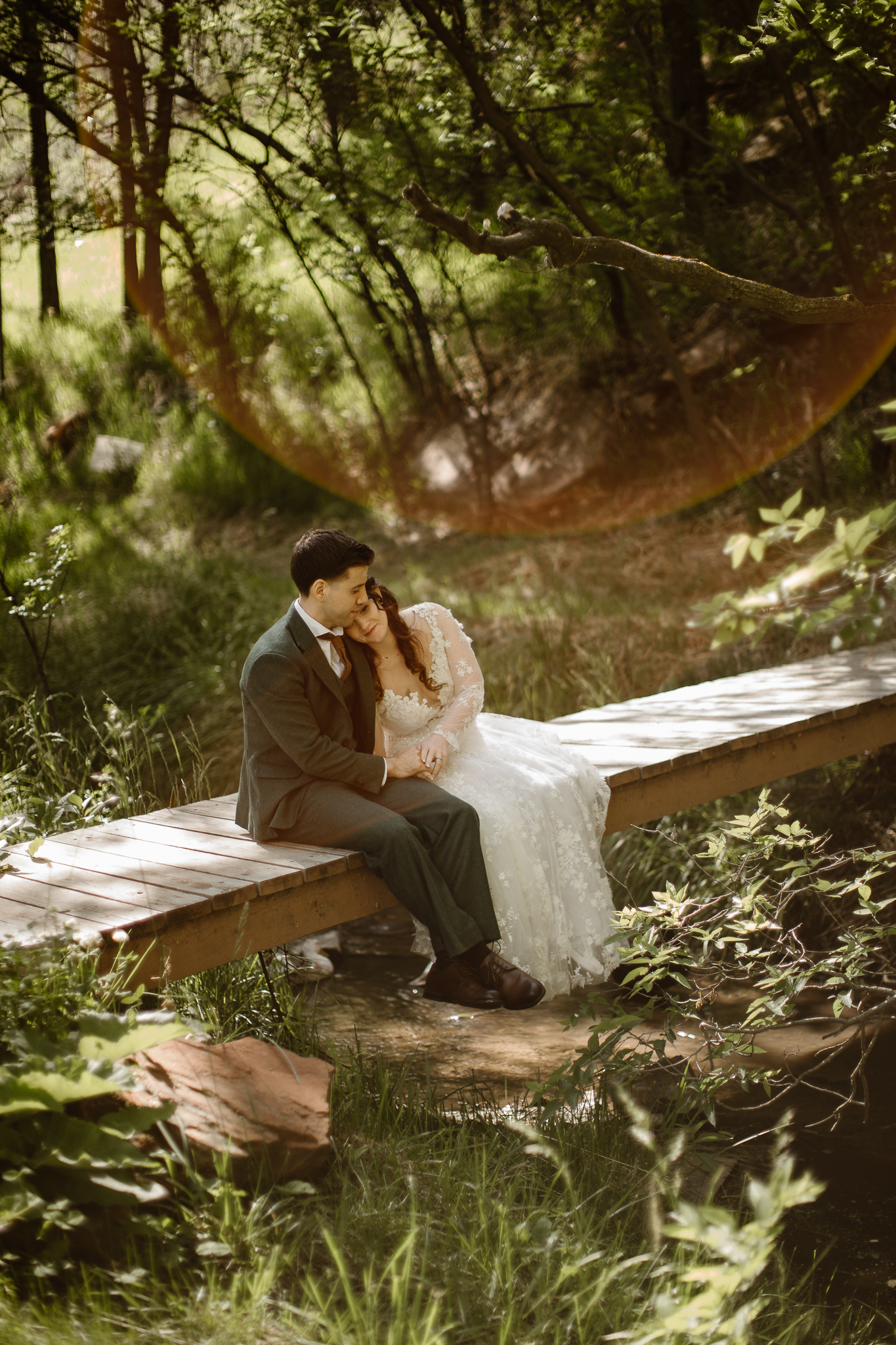 Couple embracing on a mountaintop by the water steam during a Colorado adventure elopement