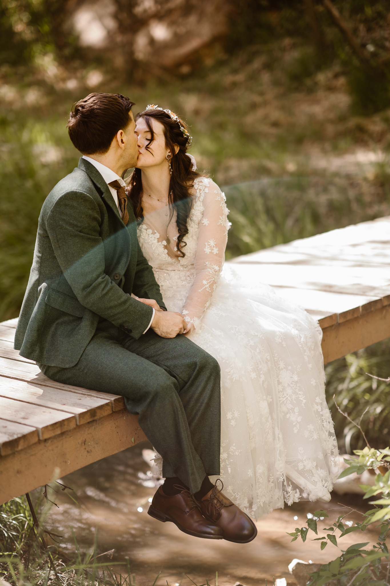 Elopement couple embracing and looking into each other's eyes on a Colorado mountaintop.