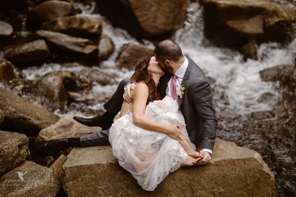 Couple embracing beside Boulder Falls, Colorado