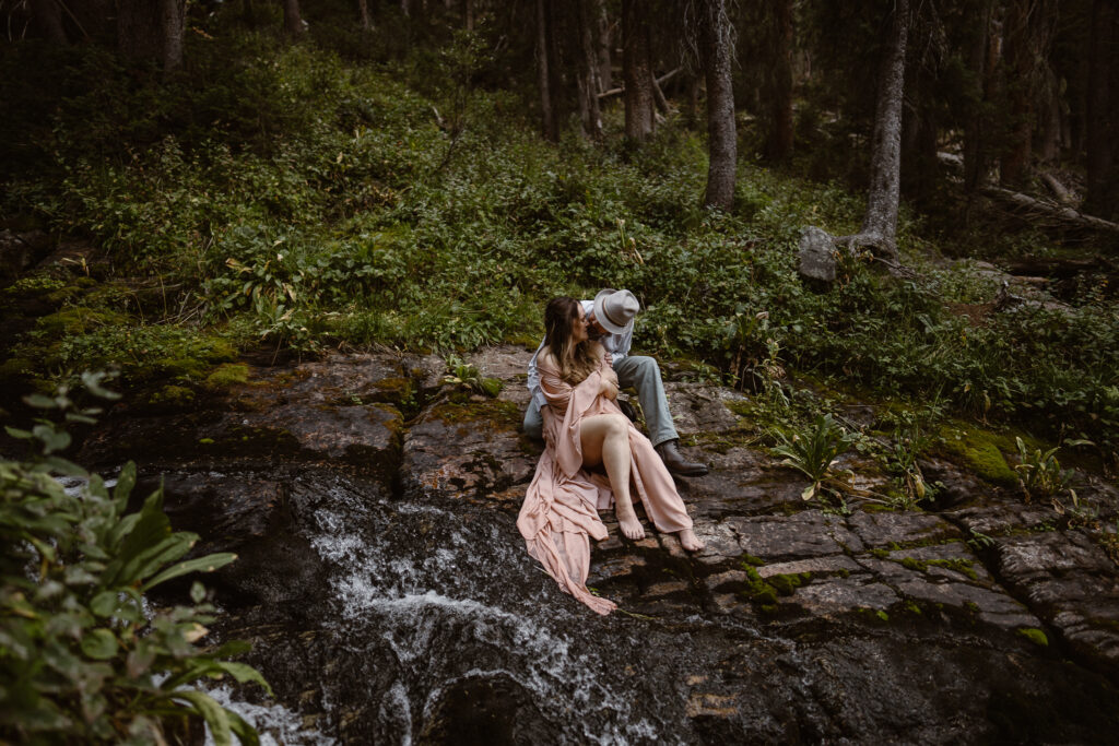 Colorado waterfall elopement photographer capturing an intimate ceremony beside a mountain waterfall.