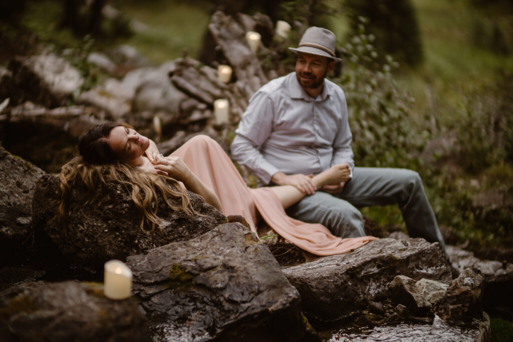 Hidden waterfall elopement in Crested Butte surrounded by lush forest and cascading water.