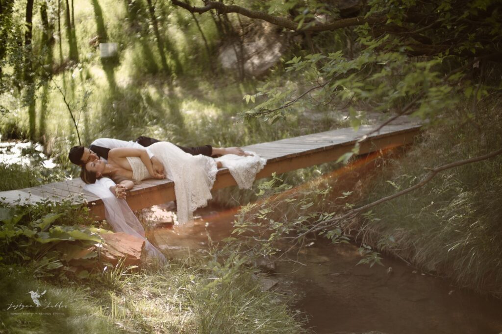 Newlyweds embracing beside Copper Falls during their Colorado waterfall elopement.